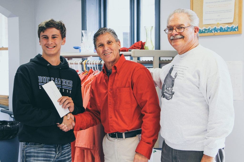 Trey Herndon, far left, receives the first ever Youth Founders Award presented by Buckhannon-Upshur Camera Club at the awards reception Wednesday. He is pictured with BUCC President Anthony Ovies, middle, and John Simons, one of the club's founding members.