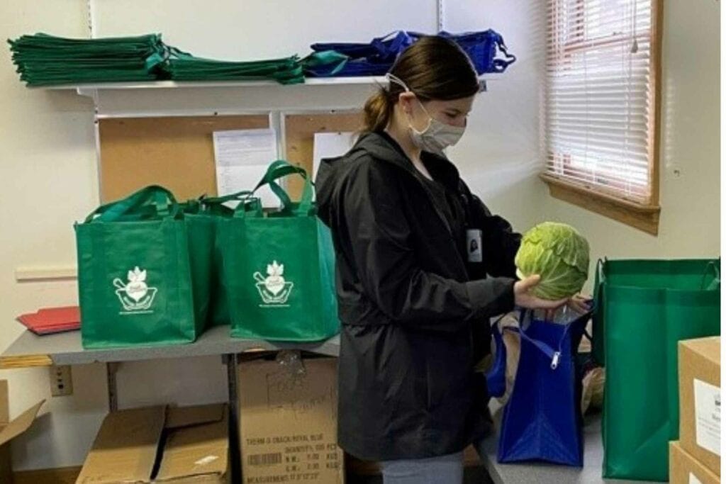 Carly Waldman, Dietetic Intern, lends a hand in preparing the fresh food bags.